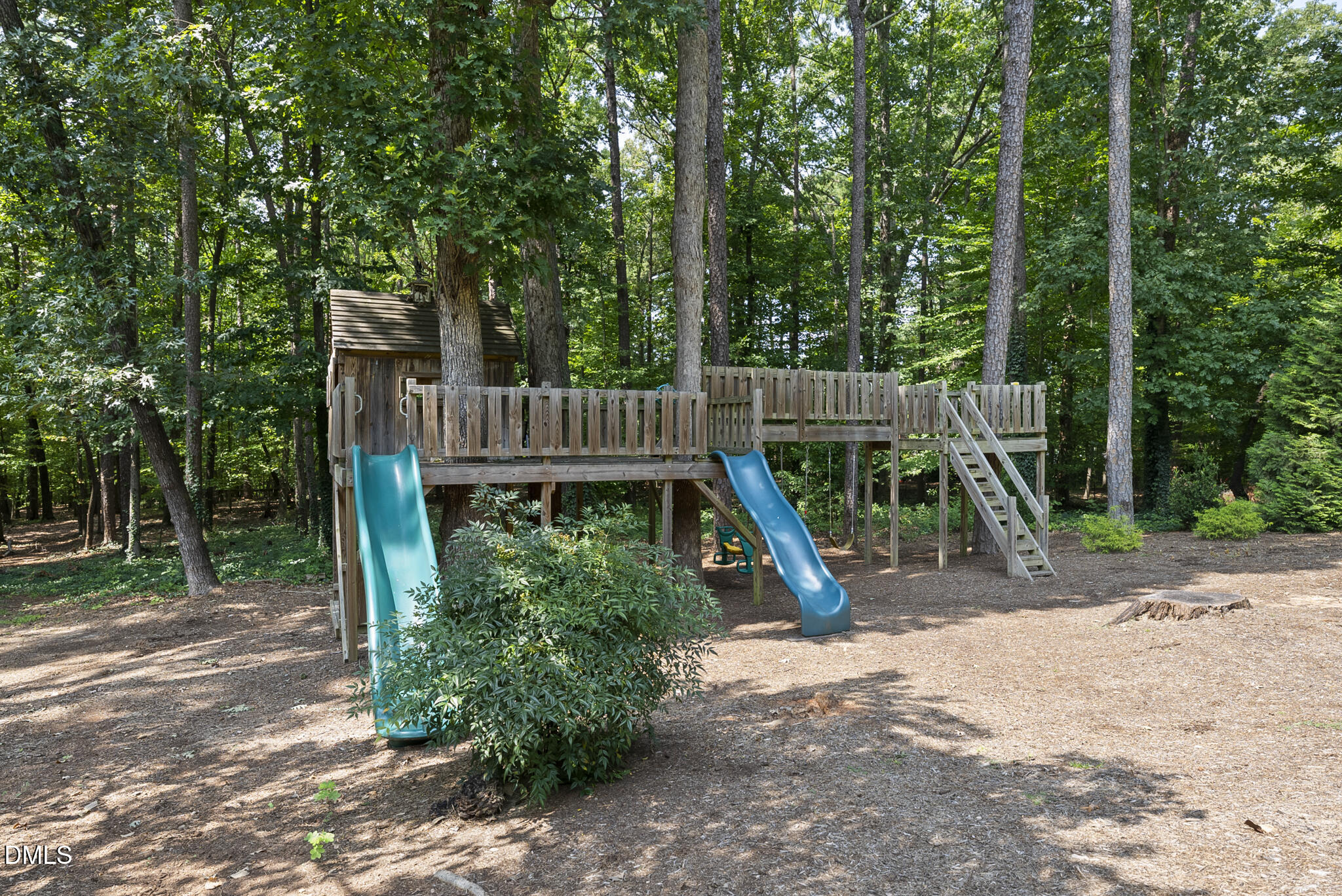 1605 Ridge Road Raleigh, NC 27607 - Photo 6 of 34 a view of a backyard with a slide trees and wooden fence