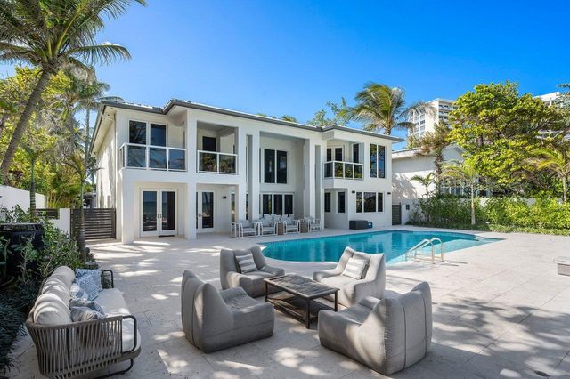 a living room with fireplace furniture and a large window