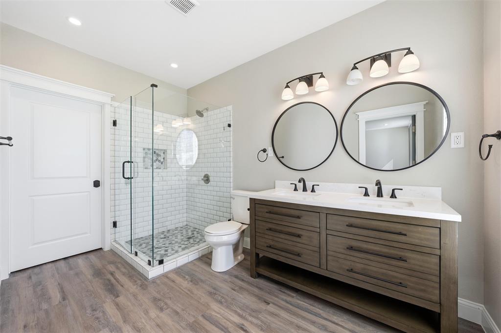 3801 South 4th Street Waco, TX 76706 - Photo 13 of 26 a bathroom with a double vanity sink mirror and toilet