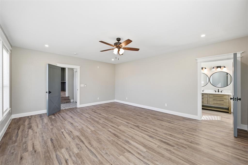 3801 South 4th Street Waco, TX 76706 - Photo 14 of 26 wooden floor in an empty room with a window