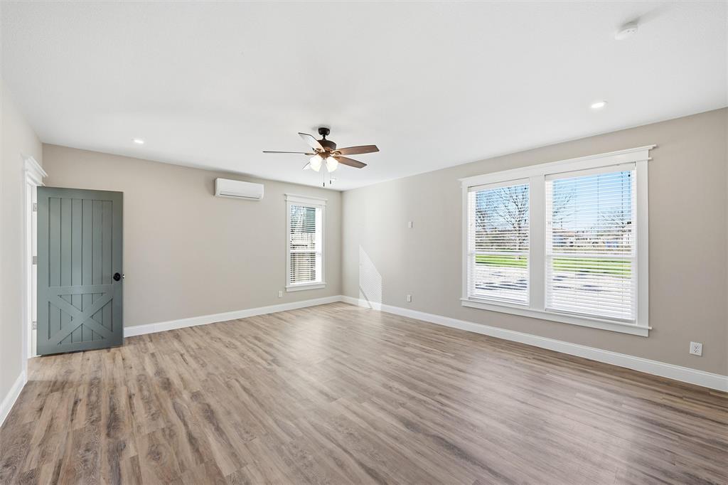 3801 South 4th Street Waco, TX 76706 - Photo 15 of 26 wooden floor in an empty room with a window