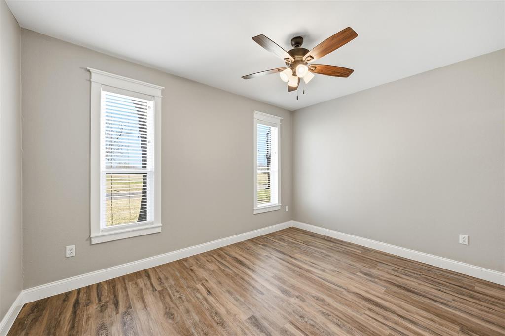 3801 South 4th Street Waco, TX 76706 - Photo 16 of 26 a view of an empty room with wooden floor and a window