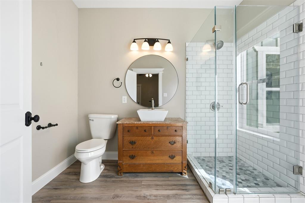 3801 South 4th Street Waco, TX 76706 - Photo 20 of 26 a bathroom with a toilet sink and mirror