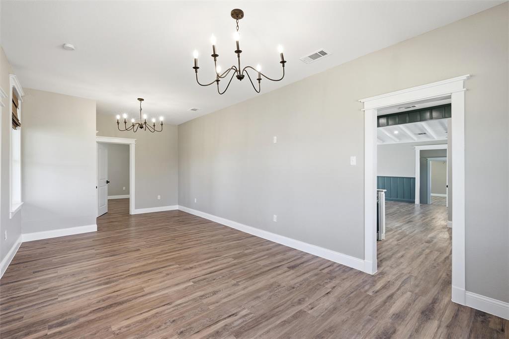 3801 South 4th Street Waco, TX 76706 - Photo 6 of 26 wooden floor in an empty room with a window