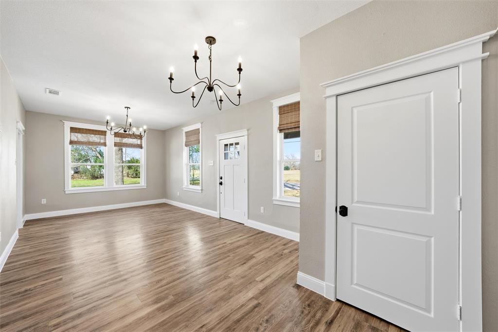 3801 South 4th Street Waco, TX 76706 - Photo 7 of 26 wooden floor in an empty room with a window