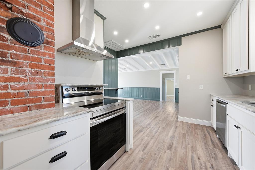 3801 South 4th Street Waco, TX 76706 - Photo 8 of 26 a kitchen with granite countertop a stove and a sink