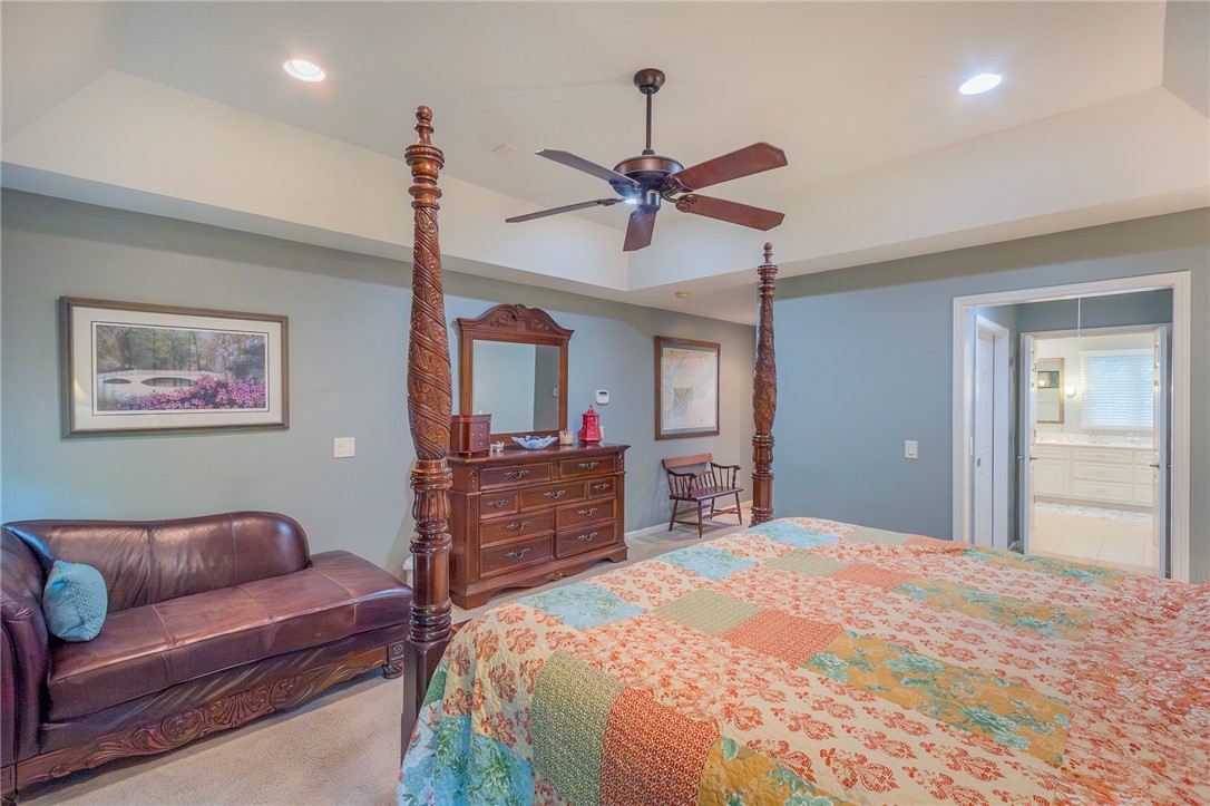 203 Oak Hollow Pendleton, SC 29670 - Photo 22 of 50 Recessed lighting and a ceiling fan illuminate this inviting primary bedroom with an adjoining private bathroom.