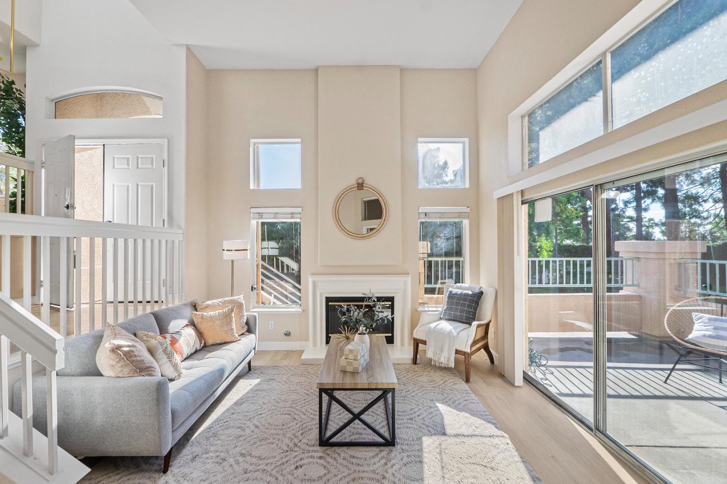 6034 Capriana Common, Unit 69 Fremont, CA 94555 - Photo 1 of 47 a living room with furniture a fireplace and a floor to ceiling window