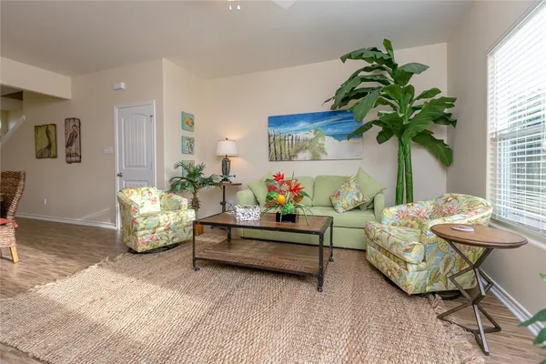 a living room with furniture and a potted plant