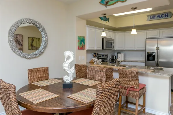 a kitchen with a dining table and chairs