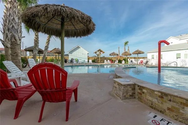 a view of a swimming pool with a table and chairs