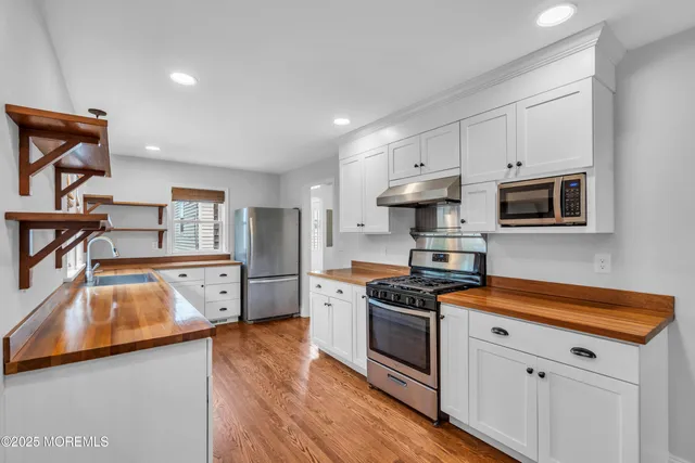 a view of an empty room with a fireplace and a window