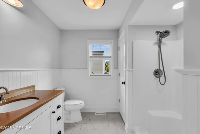 a front view of a house with a yard and green space