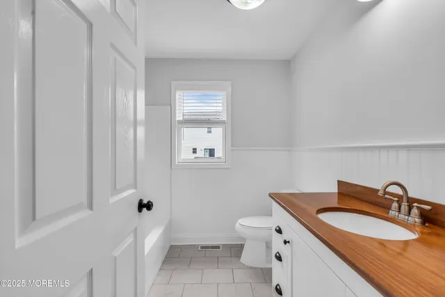 an aerial view of a house with a garden and lake view