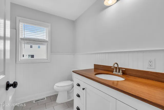 an aerial view of a house with a garden and lake view