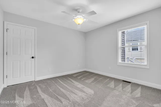 an aerial view of a city with lots of residential buildings and ocean view in back