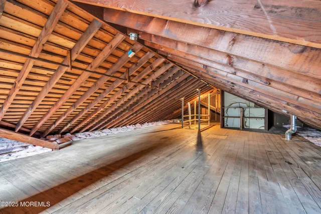 an aerial view of a house with a garden and lake view