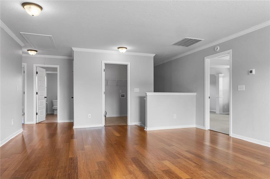 6 Pebblebrook Lane Fort Mitchell, AL 36856 - Photo 4 of 48 Unfurnished room with attic access, ornamental molding, and wood finished floors