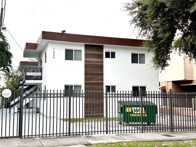 a view of a house with a wooden deck