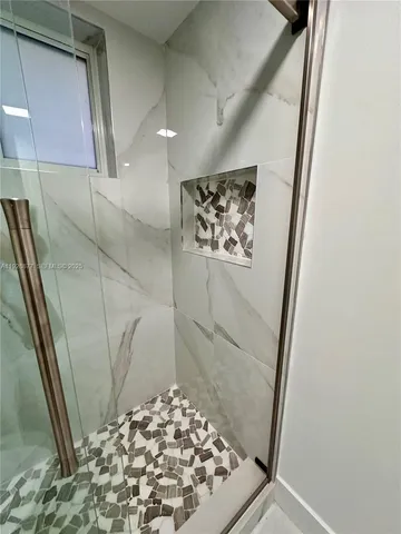 a bathroom with a shower and a sink