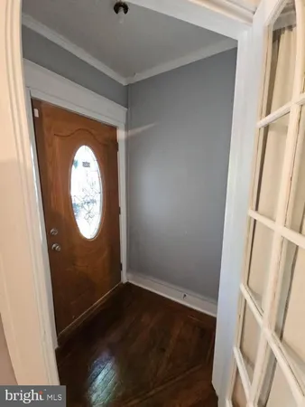 a view of hallway with wooden floor