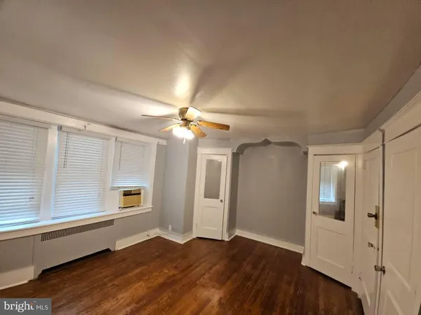 a bathroom with a sink vanity mirror and toilet