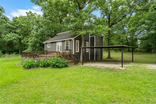 a view of a house with a backyard and a garden