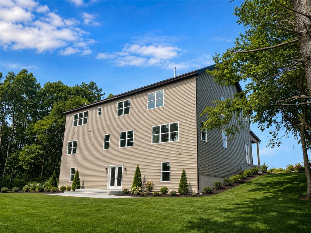 3104 Moyer Road Hellertown, PA 18055 - Photo 24 of 30 Crisp horizontal siding and multiple windows define the rear exterior of this multi-level home.