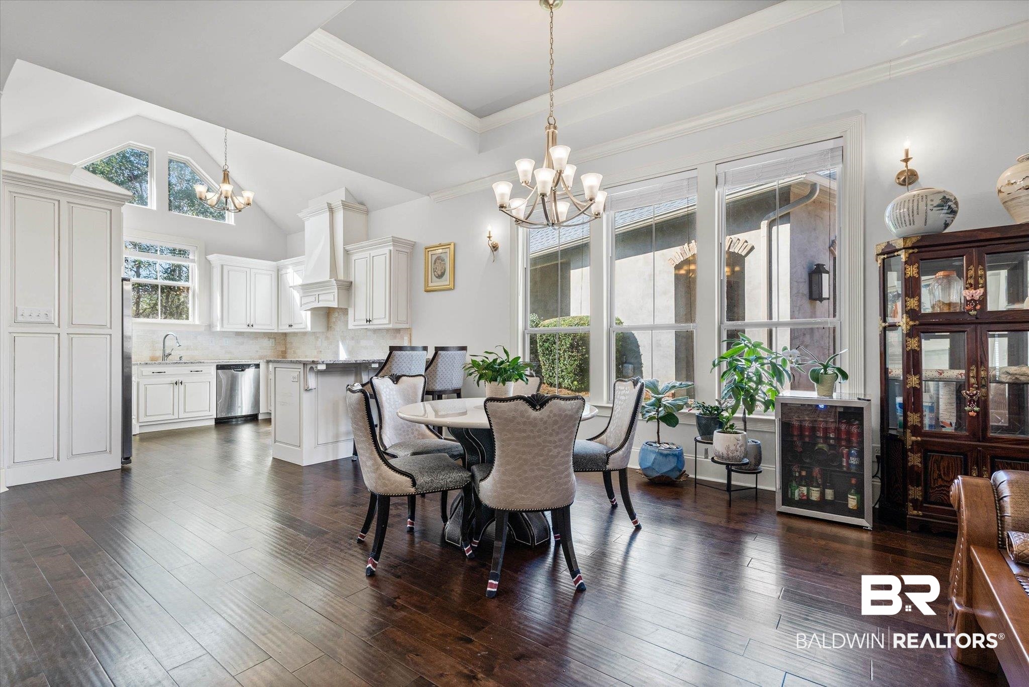 3528 Rue Royal Mobile, AL 36693 - Photo 3 of 53 Dining area featuring hanging lights, ornamental molding, dark wood-style floors, and vaulted ceiling