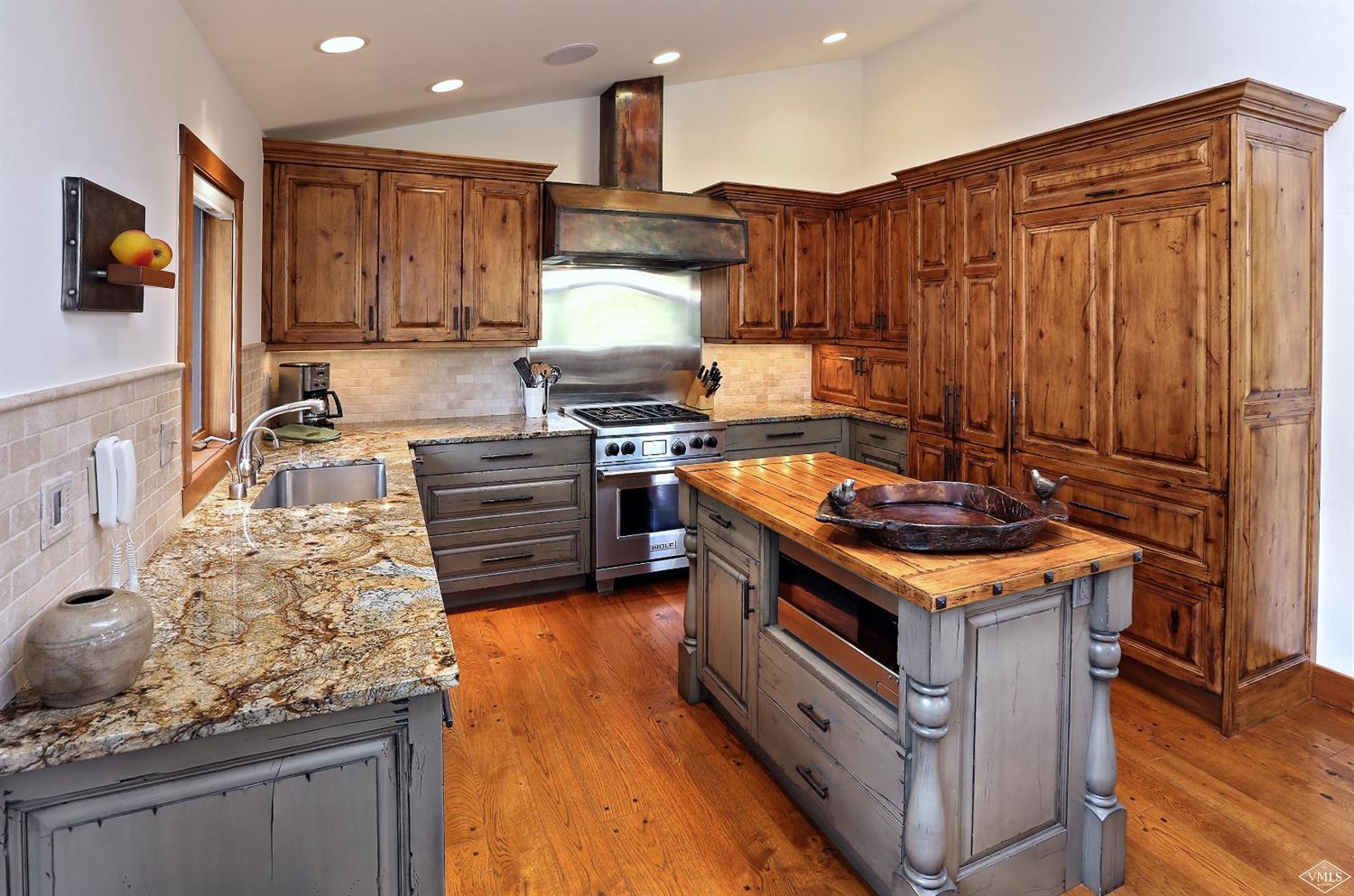 179 Knudson Ranch Road Edwards, CO 81632 - Photo 1 of 21 a kitchen with a stove and a wooden cabinets