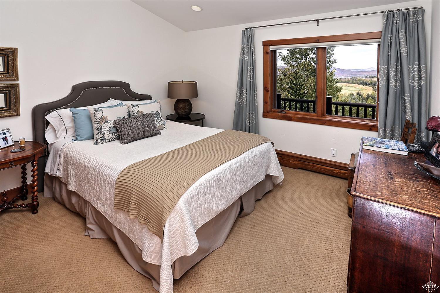 179 Knudson Ranch Road Edwards, CO 81632 - Photo 13 of 21 a bedroom with bed and a large window