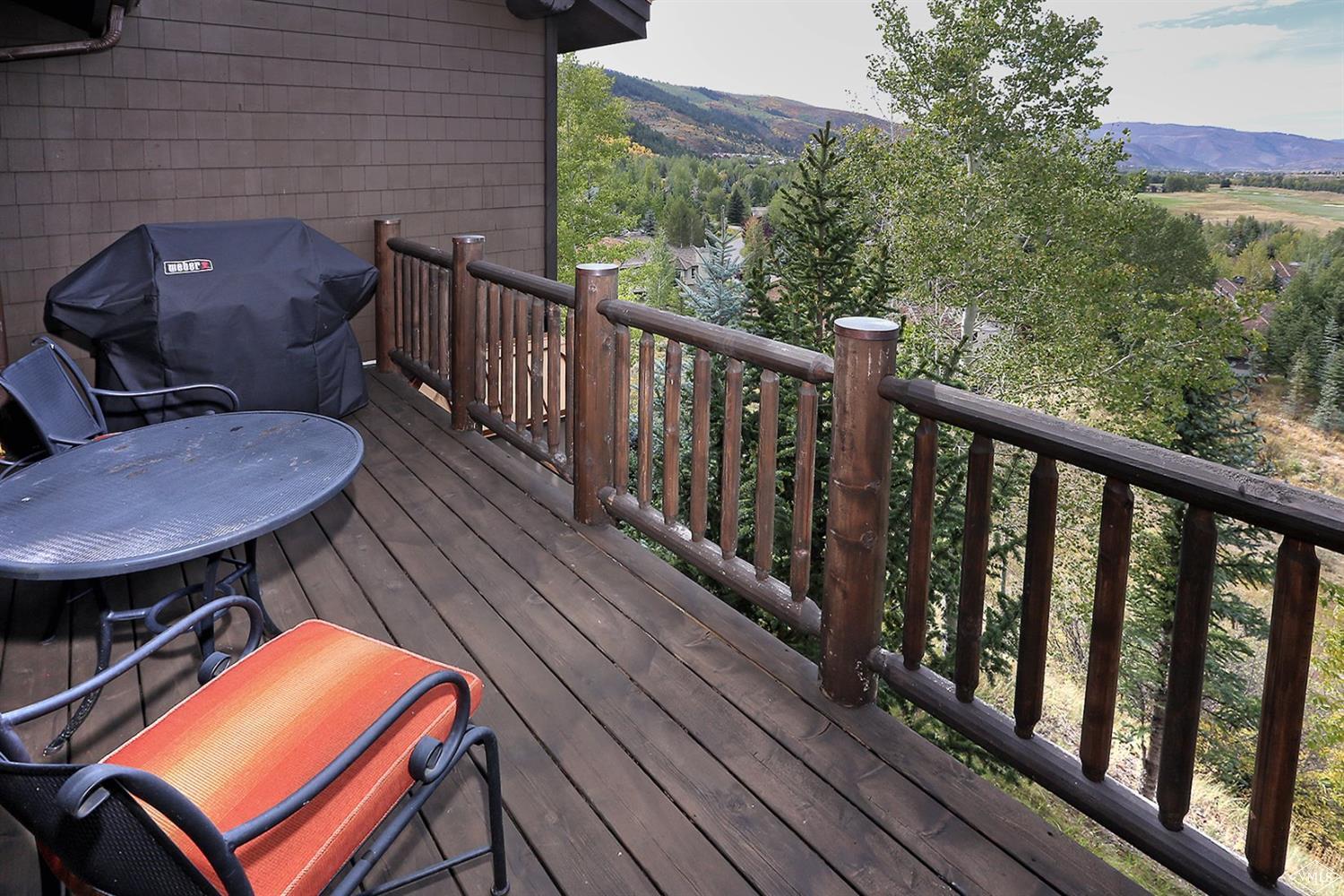 179 Knudson Ranch Road Edwards, CO 81632 - Photo 17 of 21 a balcony with wooden floor table and chairs