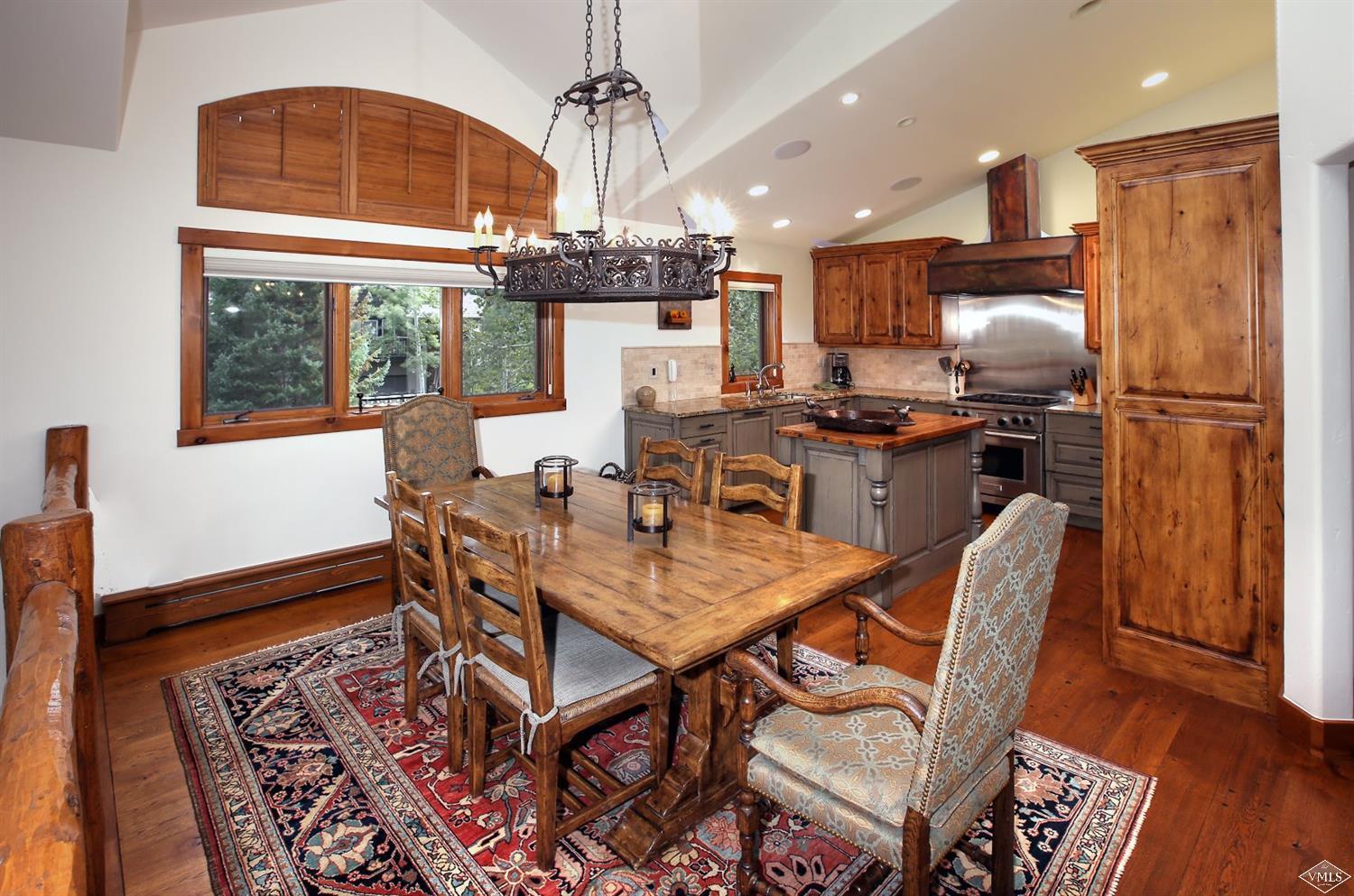 179 Knudson Ranch Road Edwards, CO 81632 - Photo 3 of 21 a dining room with furniture a chandelier and wooden floor