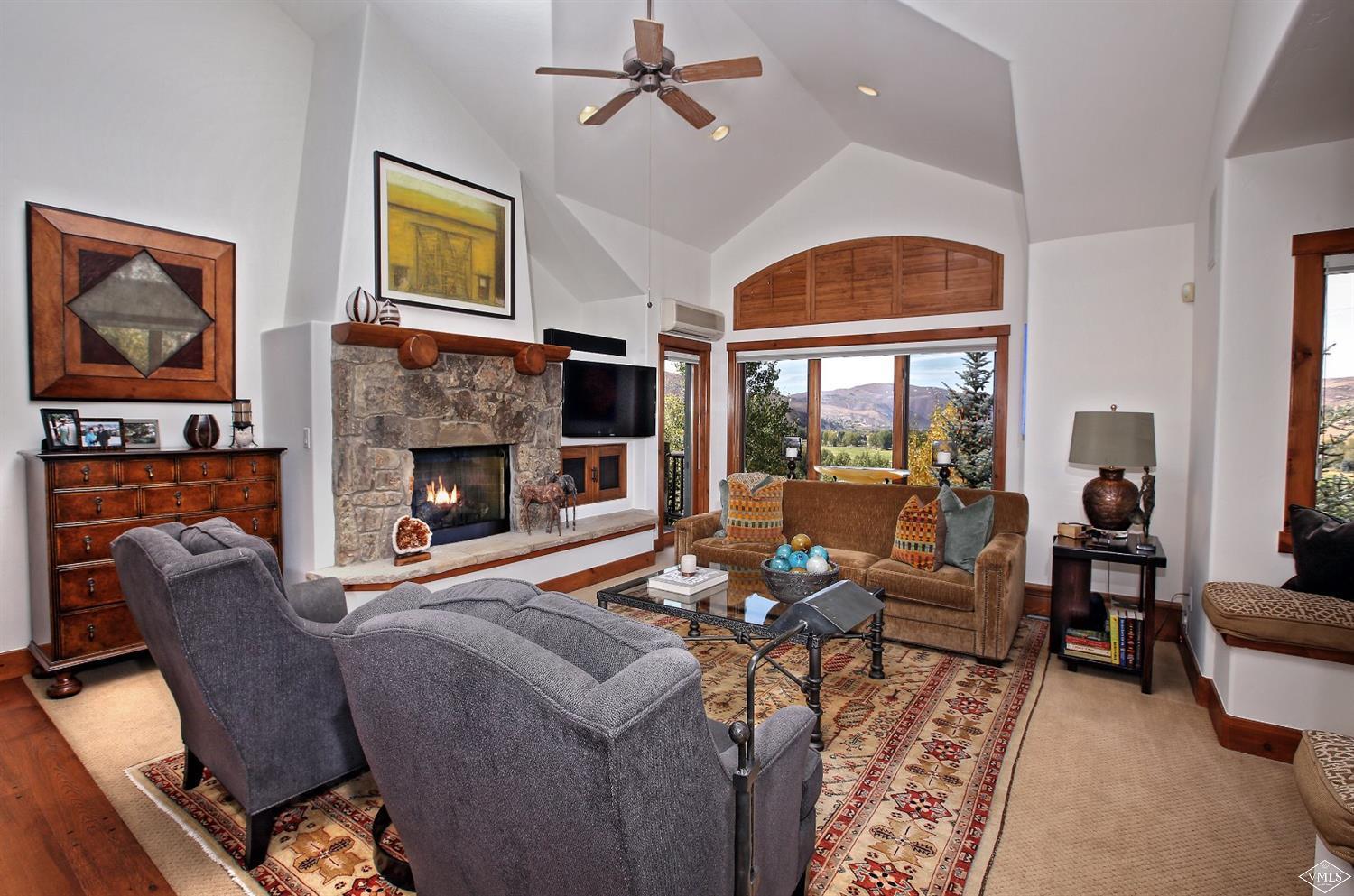 179 Knudson Ranch Road Edwards, CO 81632 - Photo 4 of 21 a living room with furniture fireplace and a large window