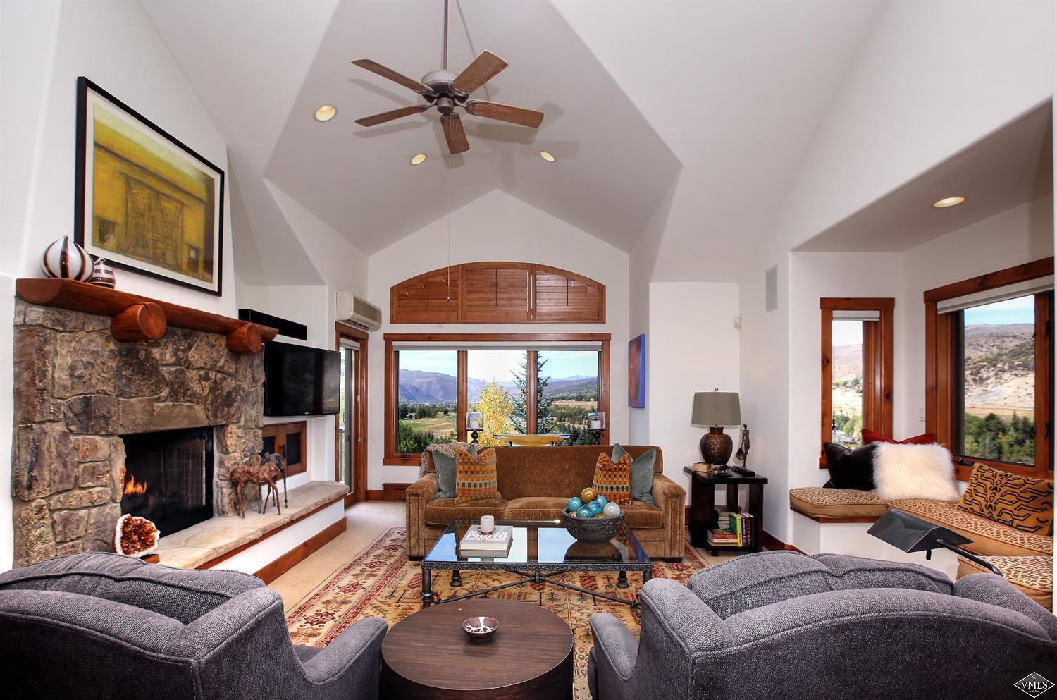 179 Knudson Ranch Road Edwards, CO 81632 - Photo 5 of 21 a living room with furniture a fireplace and a large window
