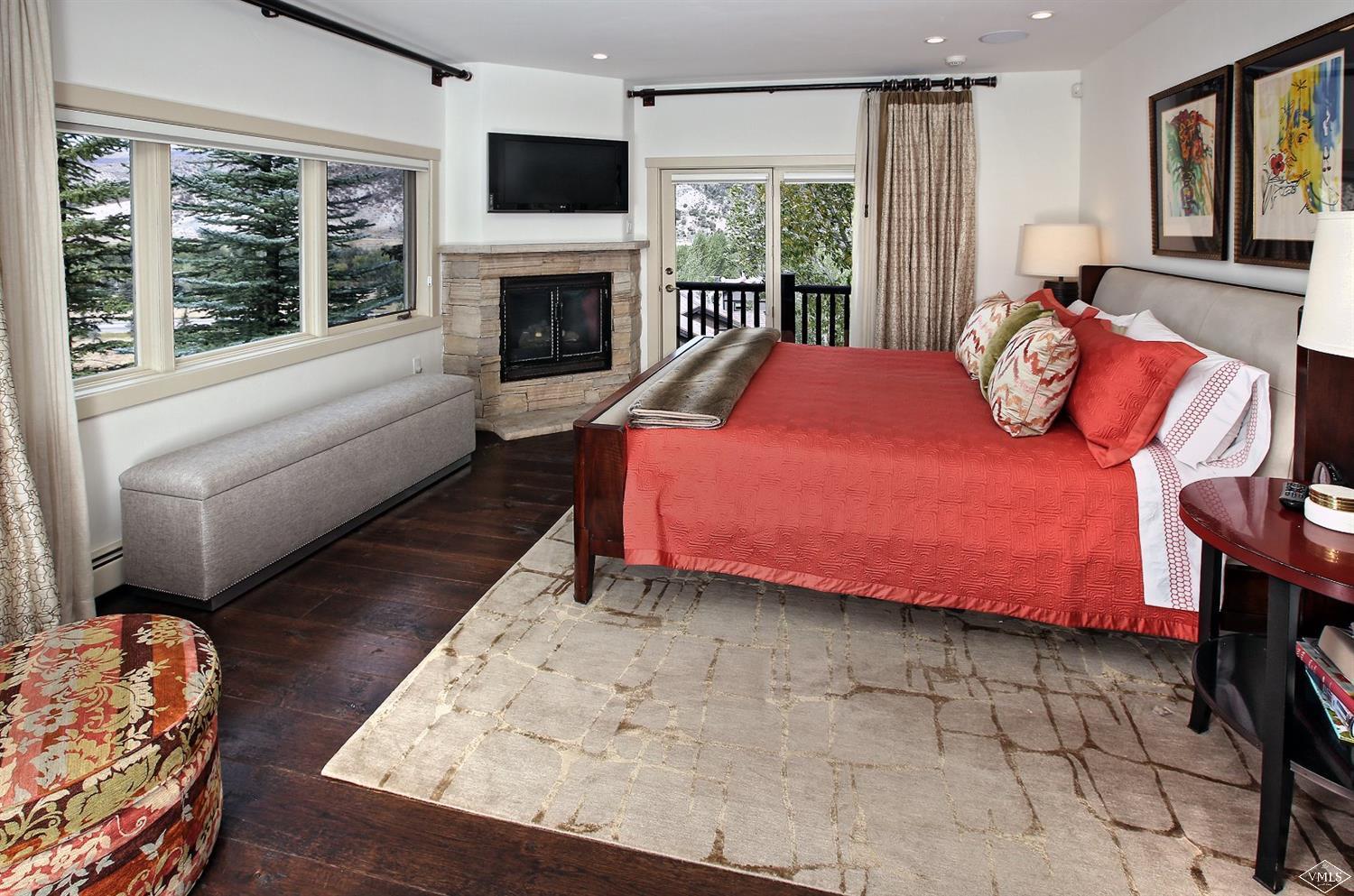 179 Knudson Ranch Road Edwards, CO 81632 - Photo 9 of 21 a bedroom with a bed and a fireplace