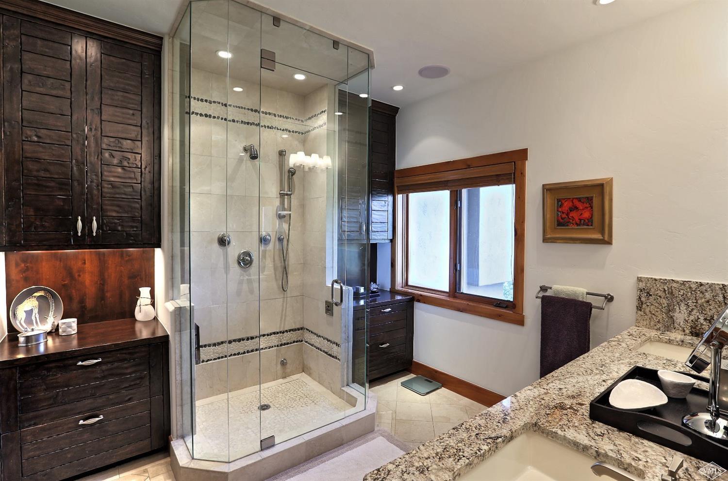 179 Knudson Ranch Road Edwards, CO 81632 - Photo 10 of 21 a bathroom with a granite countertop sink a mirror and shower