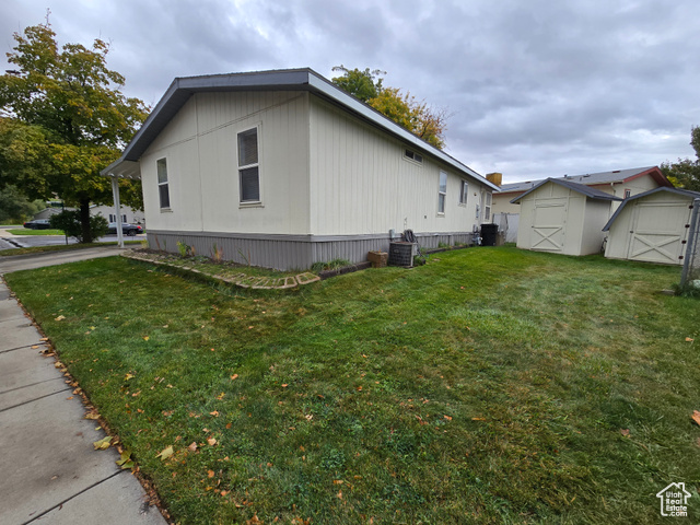 1025 North 300 West, Unit 1 Springville, UT 84663 - Photo 25 of 35 View of side of property with a storage unit and a lawn