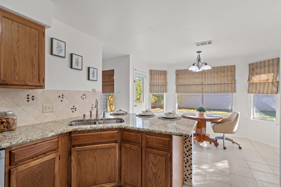 2602 Rainfall Trail Cedar Park, TX 78613 - Photo 14 of 36 a kitchen with granite countertop sink and a granite counter tops