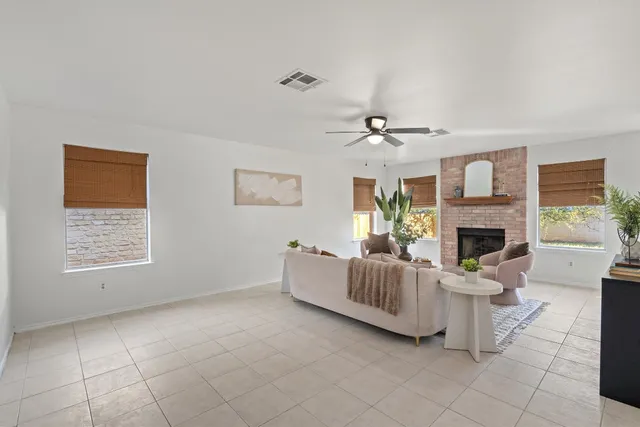 a living room with furniture a fireplace and a table
