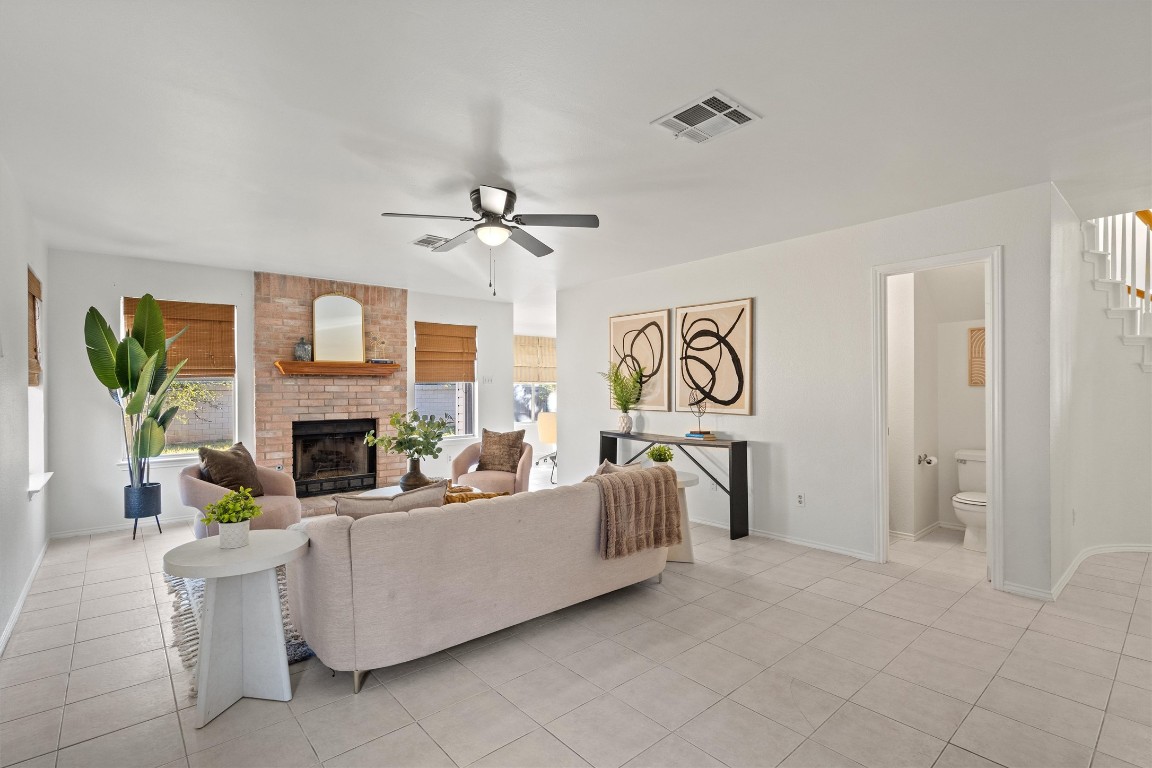 2602 Rainfall Trail Cedar Park, TX 78613 - Photo 17 of 36 a living room with furniture a fireplace and a chandelier