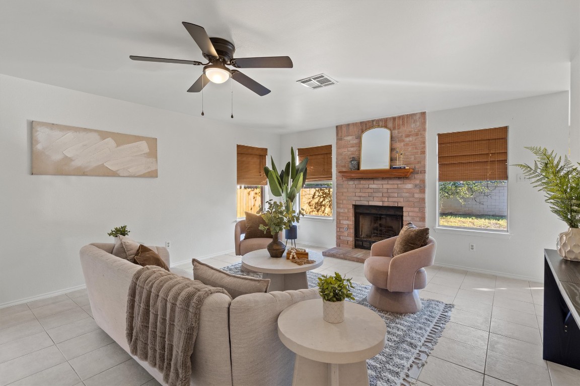 2602 Rainfall Trail Cedar Park, TX 78613 - Photo 18 of 36 a living room with furniture a fireplace and a large window