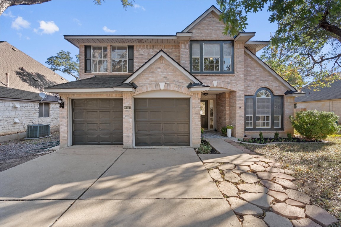 2602 Rainfall Trail Cedar Park, TX 78613 - Photo 2 of 36 a view of a white house with large windows and a small yard