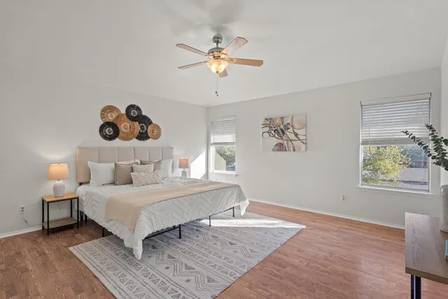 a bedroom with a bed and a chandelier