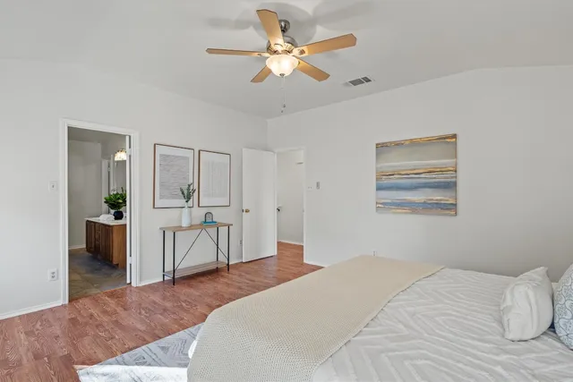 a bedroom with a bed and a chandelier