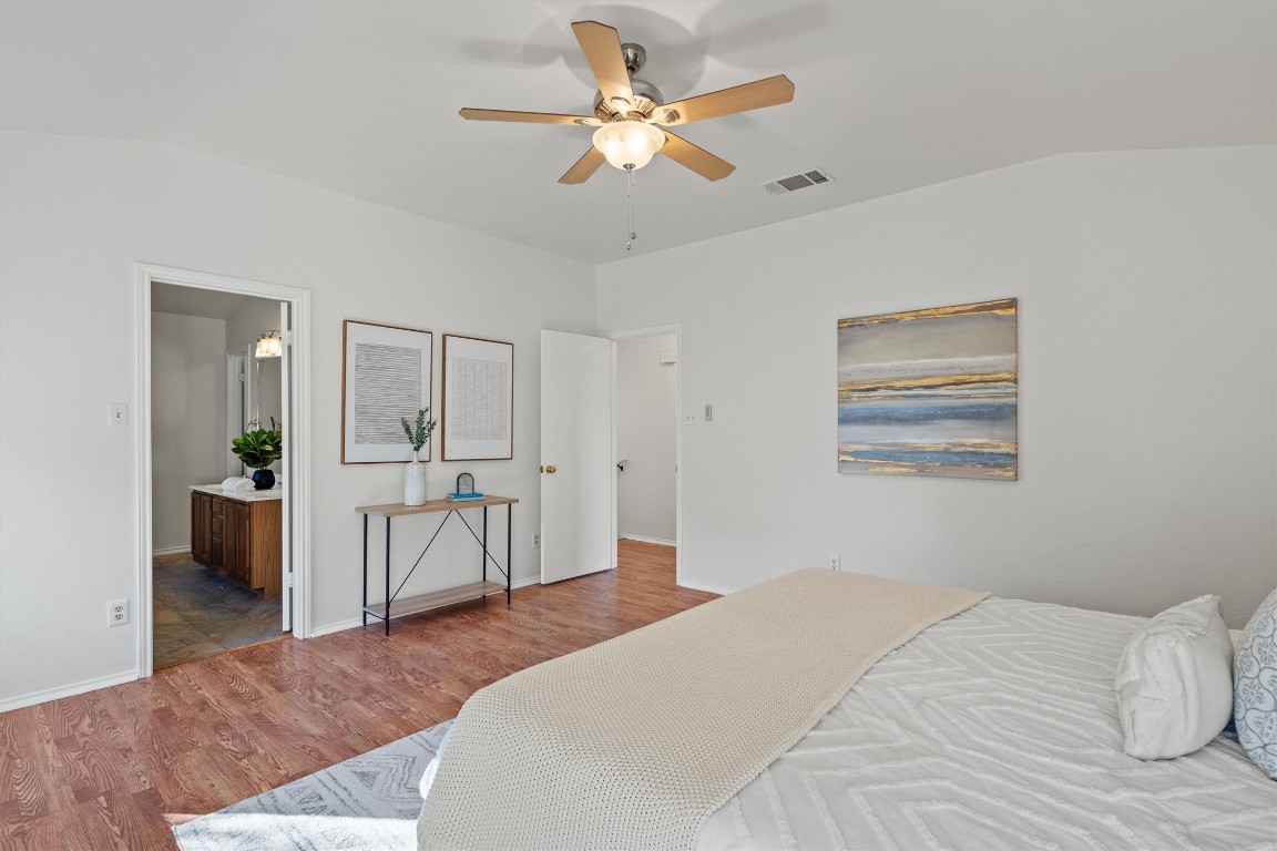 2602 Rainfall Trail Cedar Park, TX 78613 - Photo 24 of 36 a bedroom with a bed and a chandelier