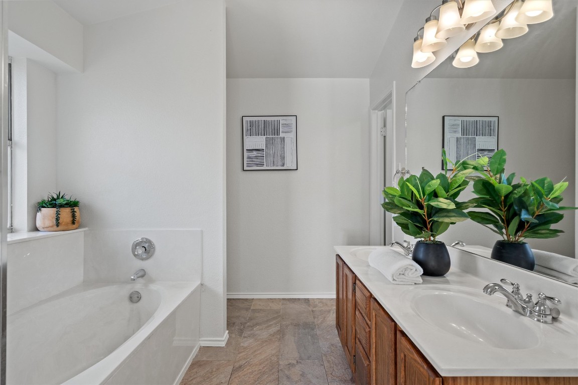 2602 Rainfall Trail Cedar Park, TX 78613 - Photo 26 of 36 a bathroom with a double vanity sink a tub and a mirror