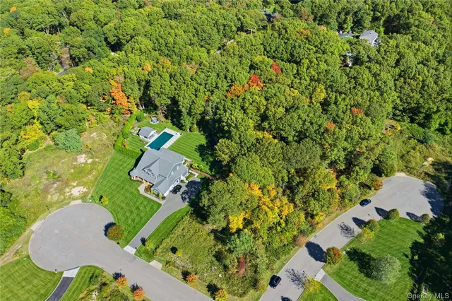 an aerial view of a house with yard swimming pool and outdoor seating