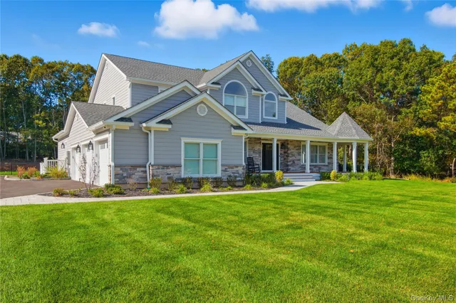 a front view of a house with a garden and patio