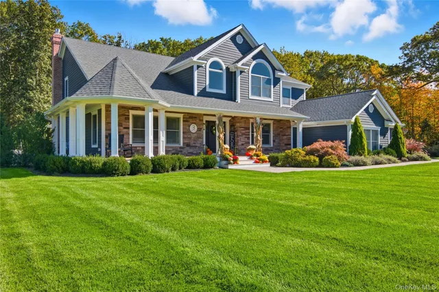 a front view of house with yard and green space
